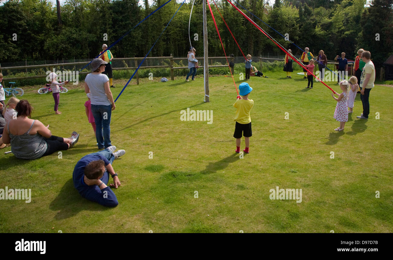 Children dance around a maypole at an English country festival