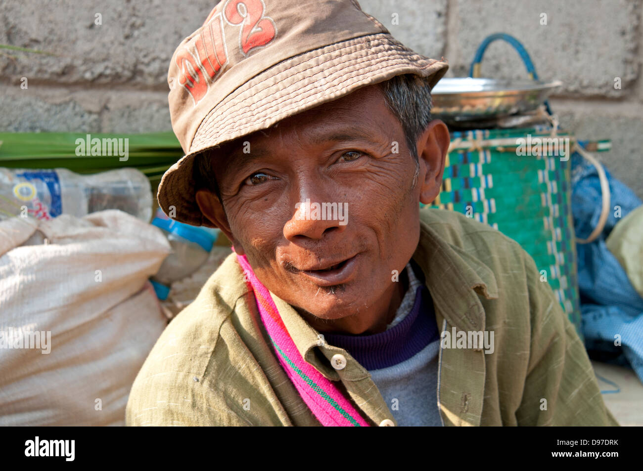 Man wearing hat smiling at the camera in a market Myanmar (Burma) Stock Photo
