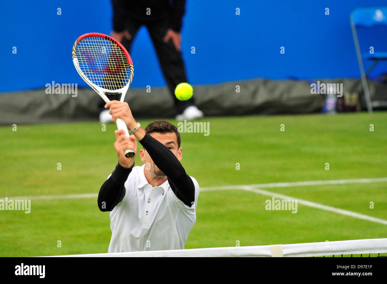 Grigor Dimitrov (Bulgaria) at the Aegon Tennis Championship, Queens Club, London. 12th June 2013 playing an unconventional overhead shot near the net Stock Photo