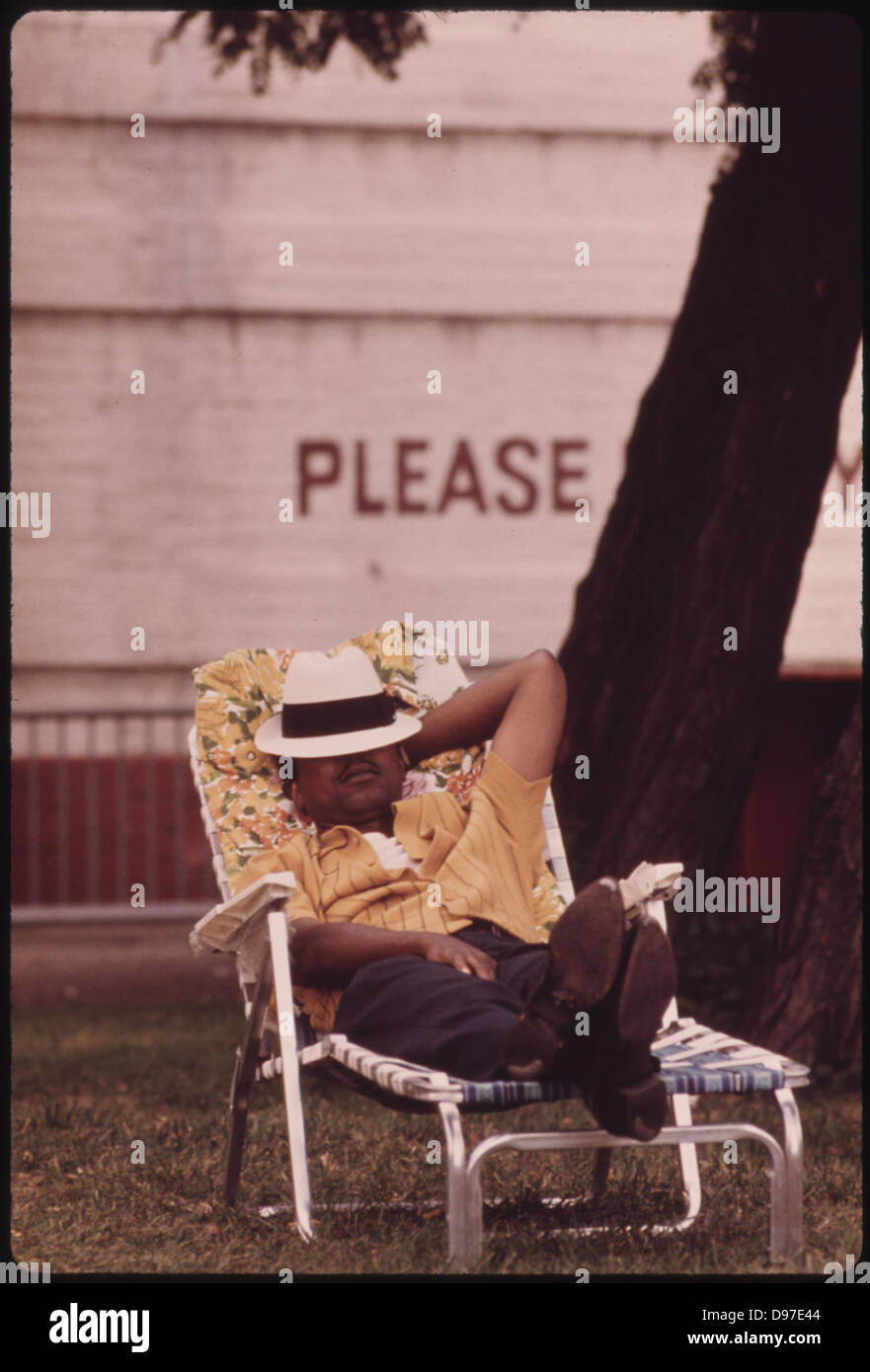 Black Man Enjoying A Nap On A Chaise Lounge On Chicago's South Side, 08/1973 Stock Photo
