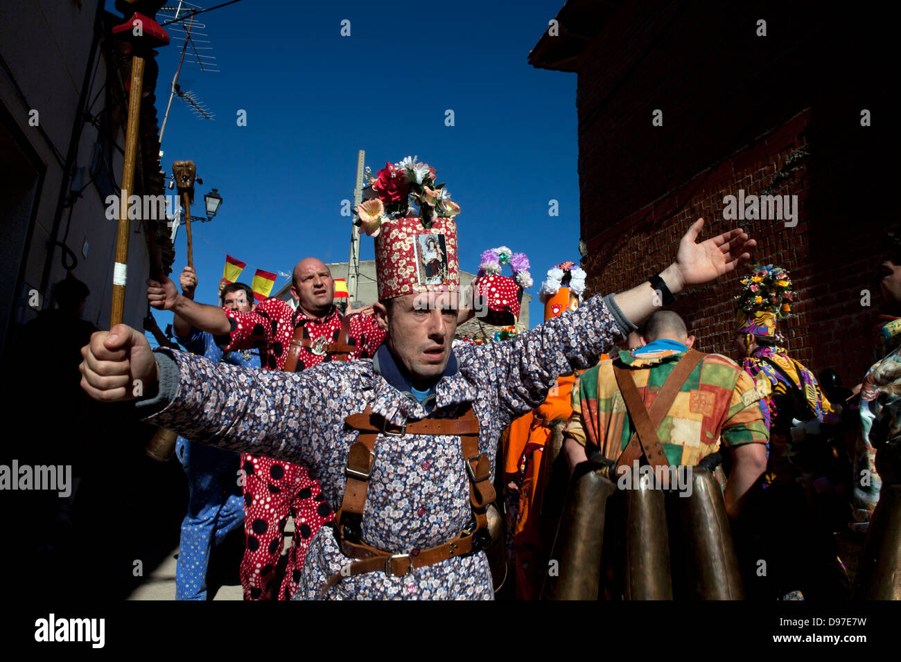 A group of 'devils' cross the streets of town dancing and screaming Stock Photo