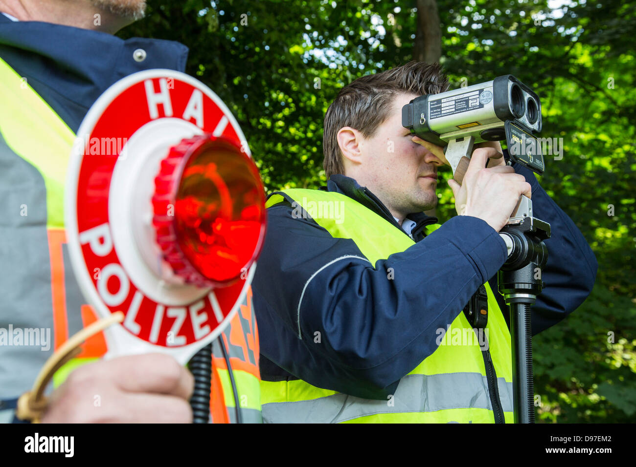 Police speed control, speed measuring with a laser speed gun. Stock Photo