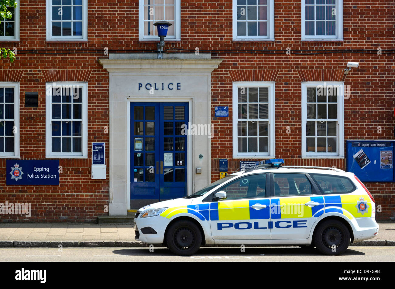Essex police patrol car parked outside Epping Police Station with blue lamp above entrance door Essex England UK Stock Photo
