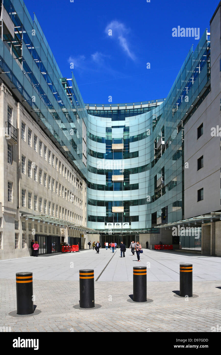 Security bollards across entrance to major modern building additions at BBC Broadcasting House courtyard London England UK Stock Photo