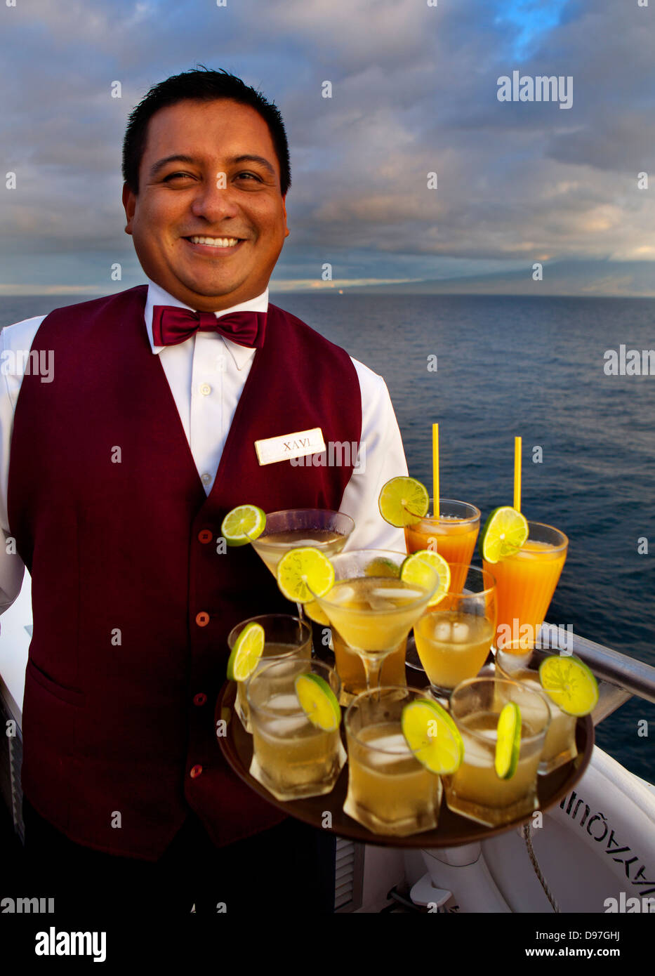 Cocktail hour on board the Grand Odyssey with Xavi, the barman, serving the guests at sunset, Galapagos Islands, Ecuador Stock Photo