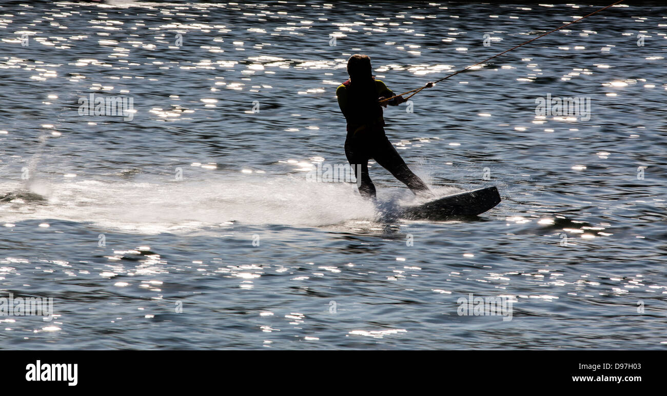 Water ski, beginners are drawn from the automatic towing unit on the water. Stock Photo