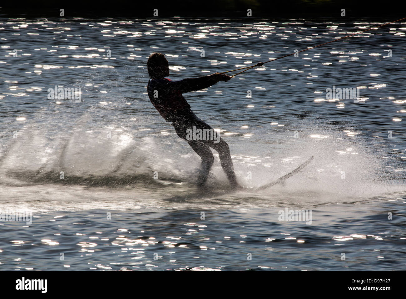 Water ski, beginners are drawn from the automatic towing unit on the water. Stock Photo
