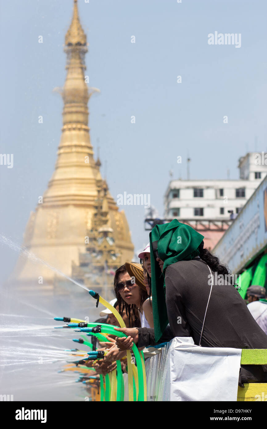 people are spraying water from hoses at Thingyan - water festival Stock Photo