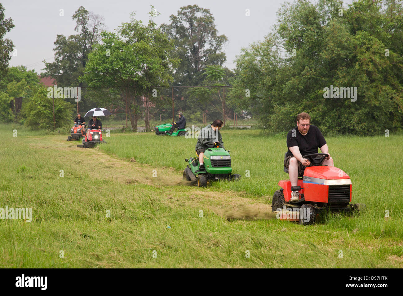The Detroit Mower Gang, an informal group of volunteers, cuts the grass in parks that the city can no longer afford to maintain. Stock Photo