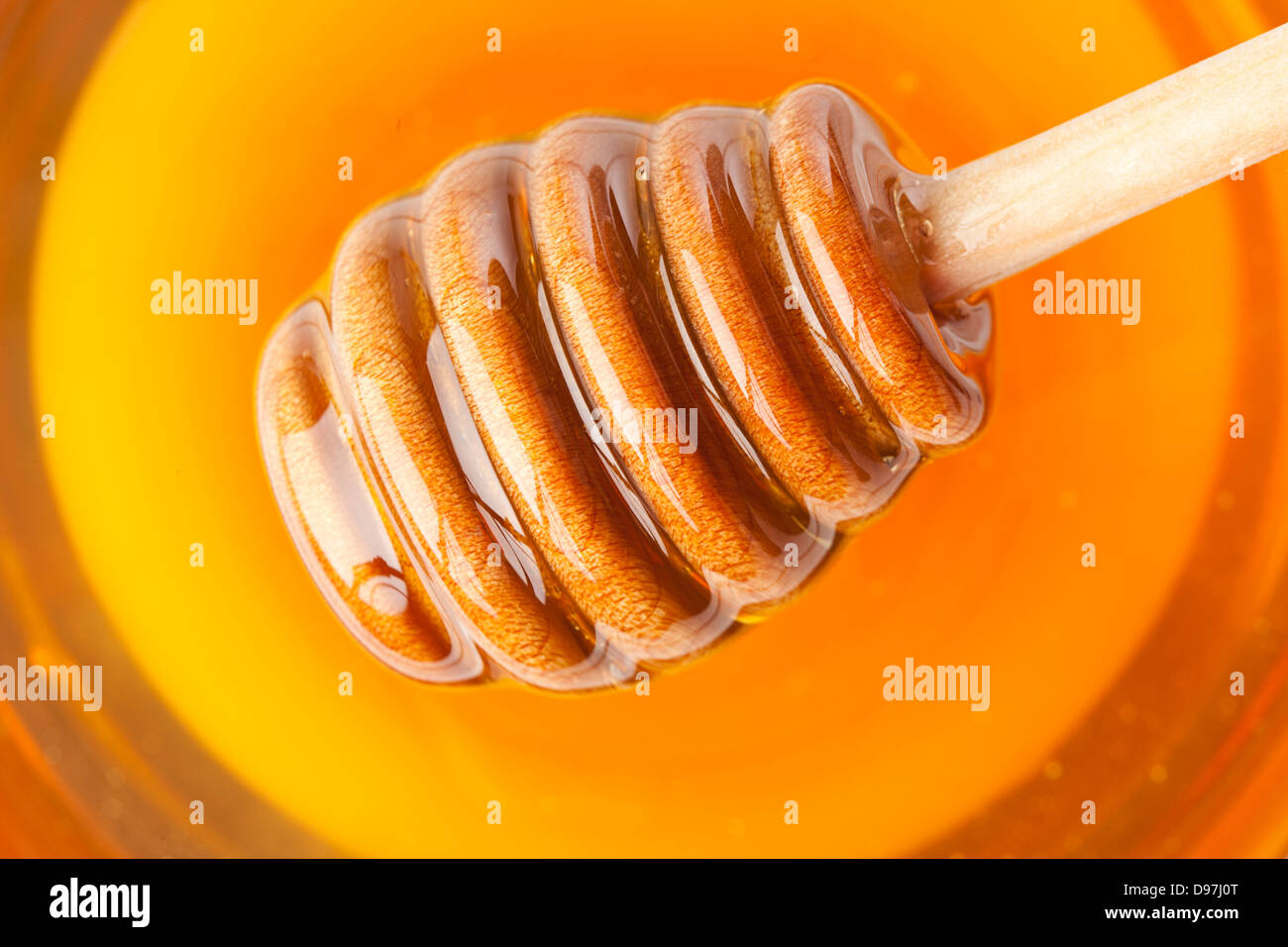 Golden Organic Honey against a back ground Stock Photo