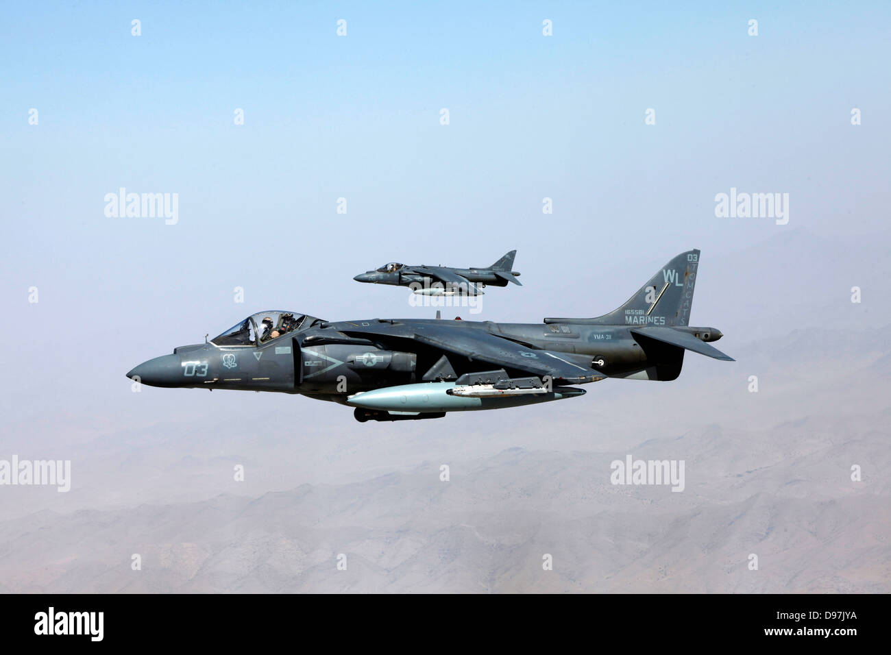 Two US Marine Corps AV8B Harrier jump jet aircraft fly in formation