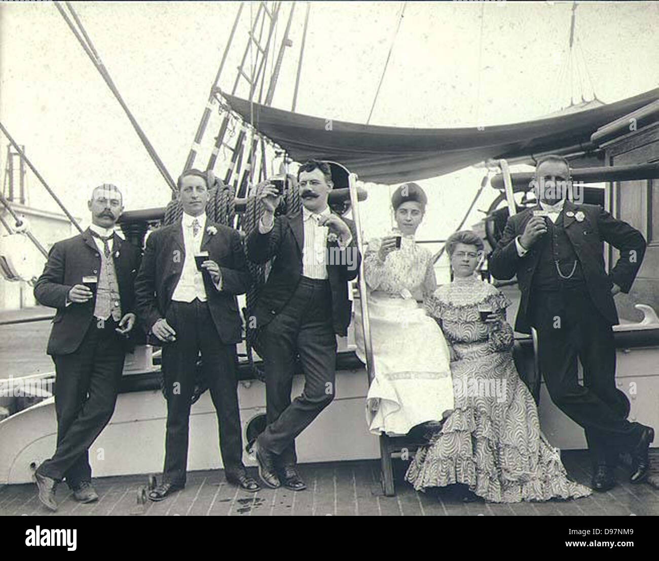 Four men and two women on the deck of the three-masted bark LAMORICIERE, Puget Sound port, Washington Stock Photo