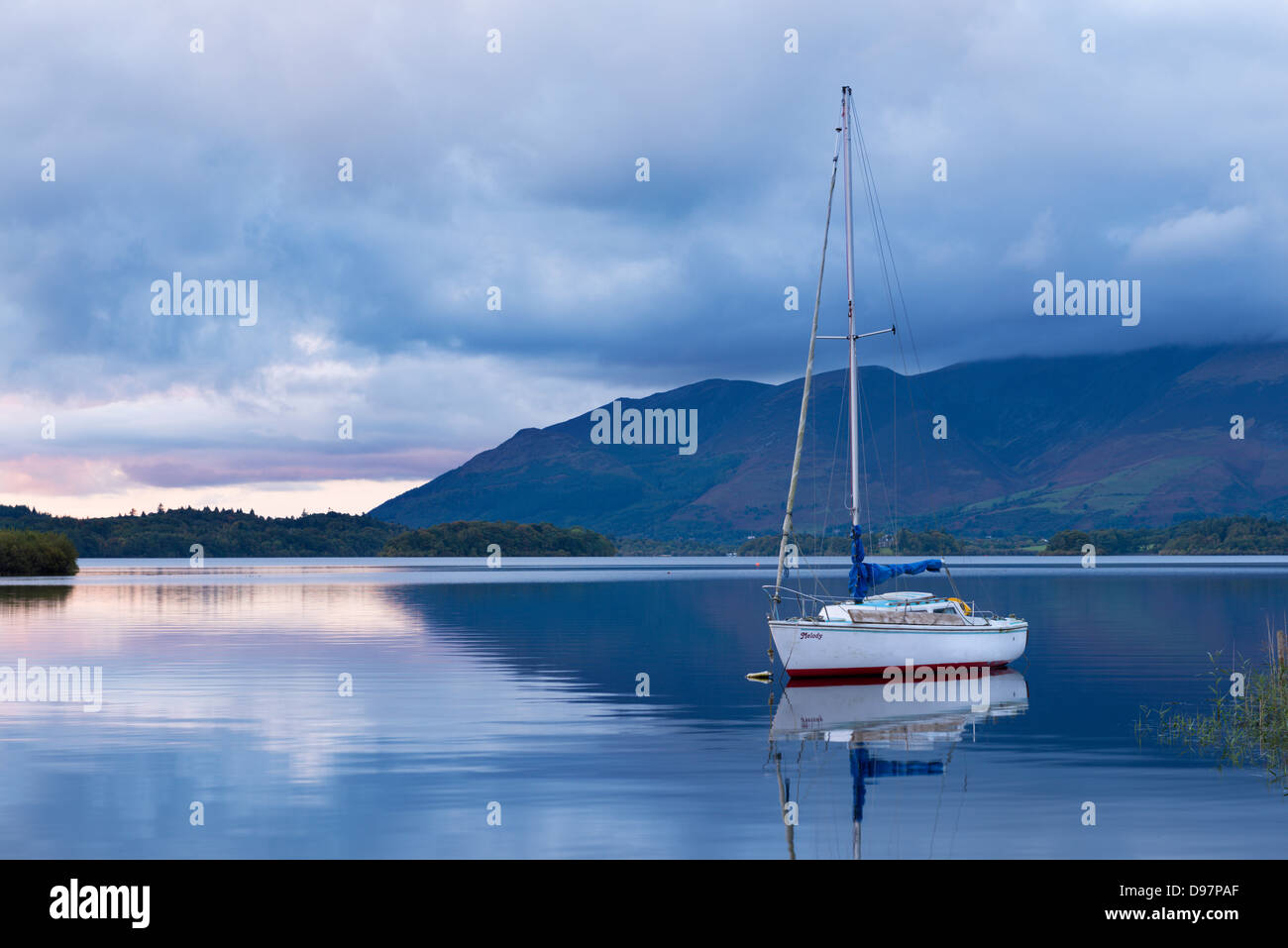 Yacht anchored on Derwent Water at twilight, Lake District, Cumbria, England. Autumn (October) 2012. Stock Photo