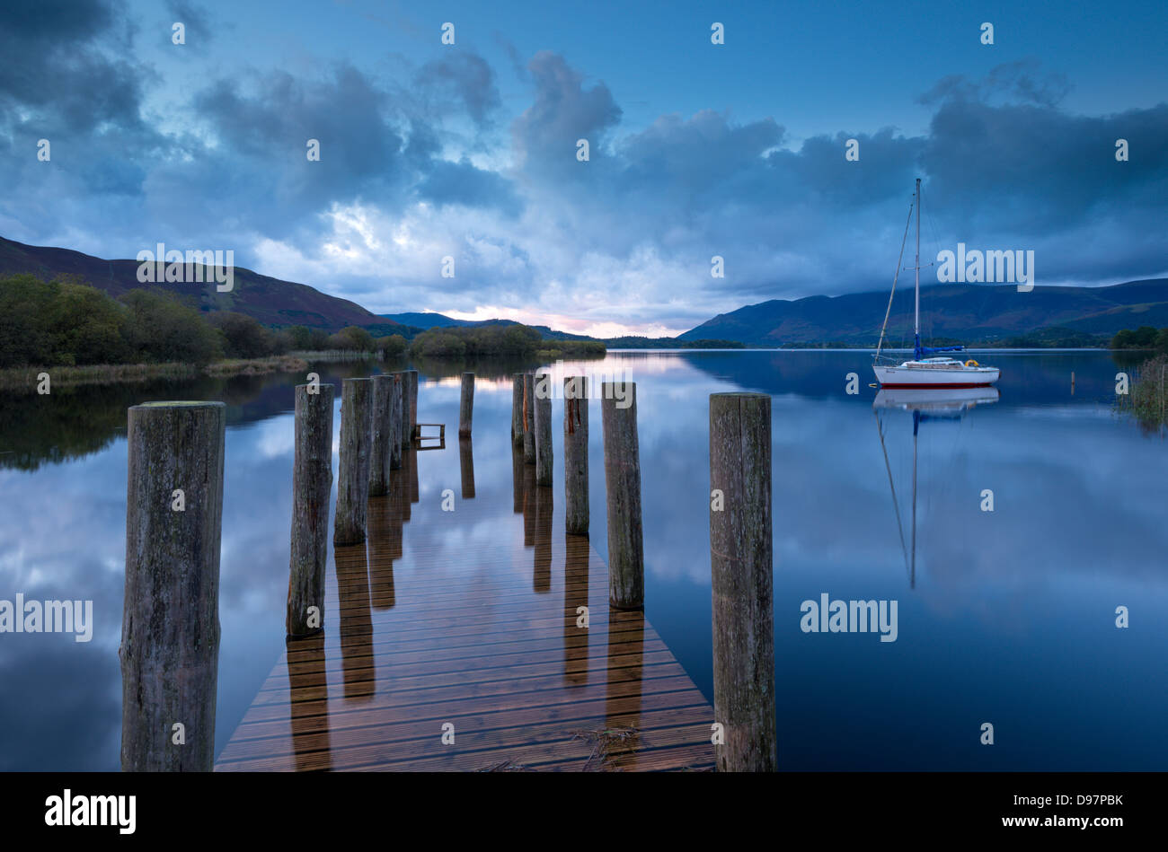 Wooden jetty and yacht on Derwent Water near Lodore, Lake District, Cumbria, England. Autumn (October) 2012. Stock Photo