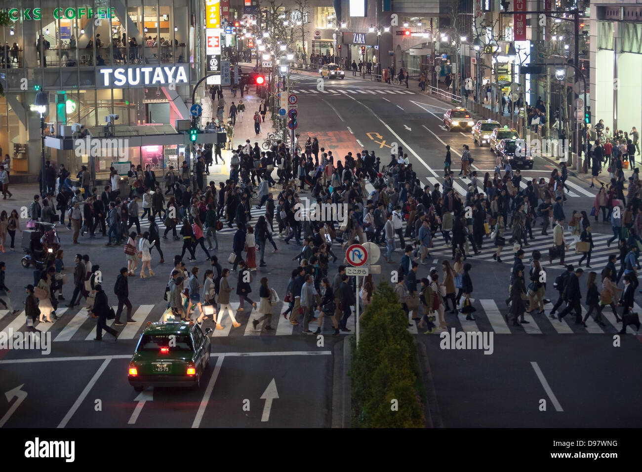 Shibuya Crossing is famous place for scramble crossing in Tokyo city, Japan. Night view. People passing a road Stock Photo