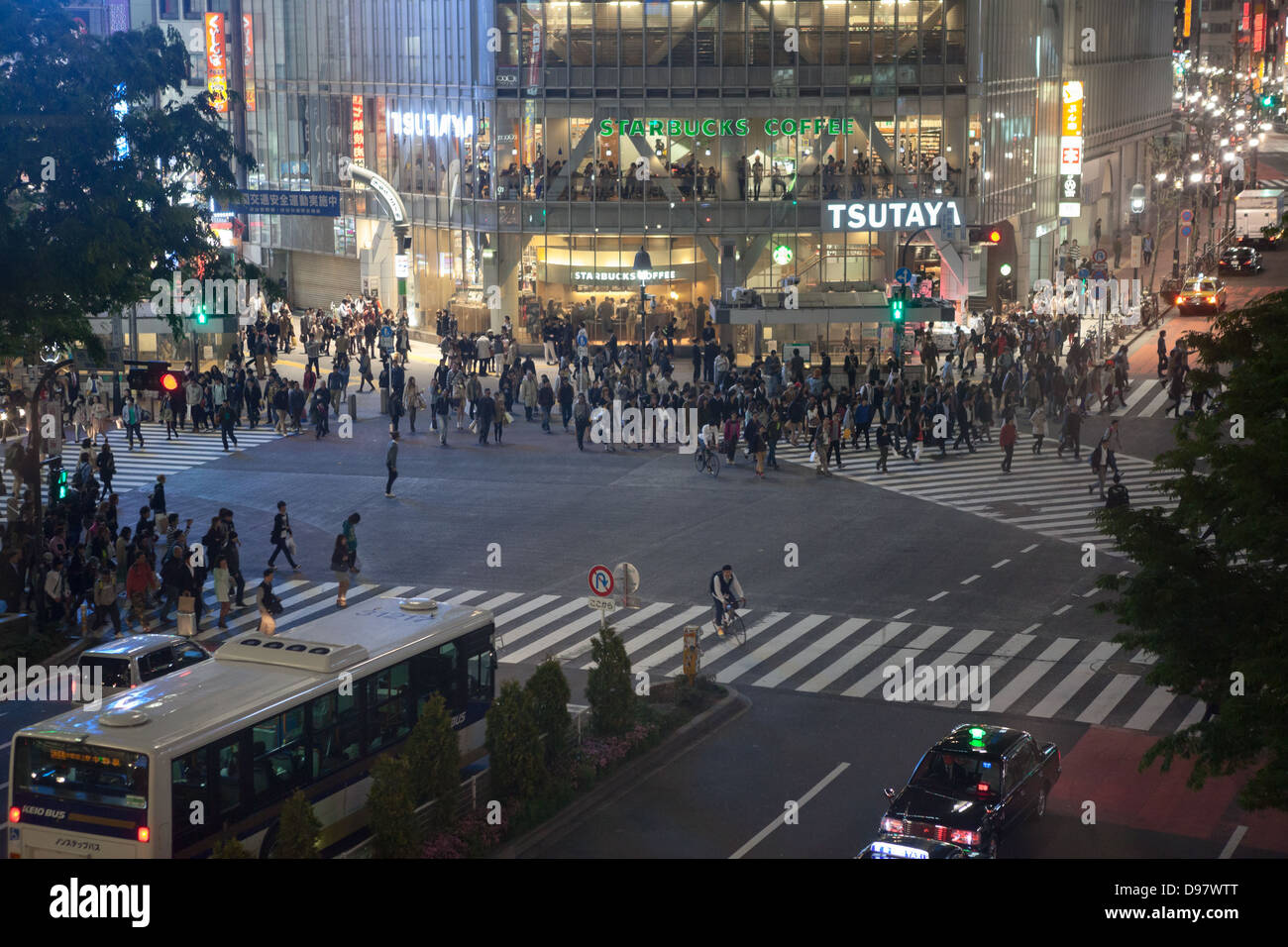 Shibuya Crossing is famous place for scramble crossing in Tokyo city, Japan. Night view. People starting to pass intersection Stock Photo