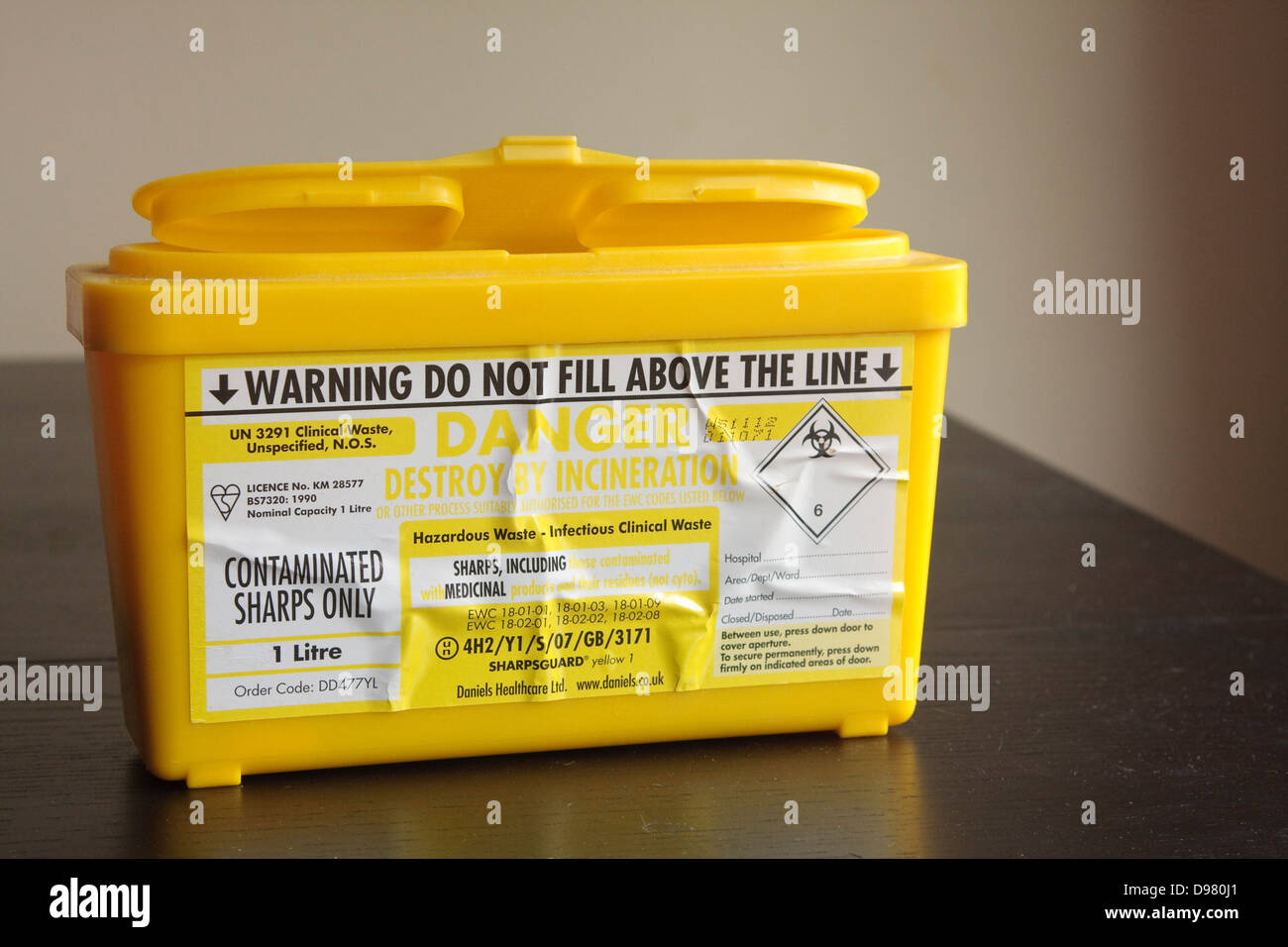 Yellow medical sharps bin Stock Photo Alamy