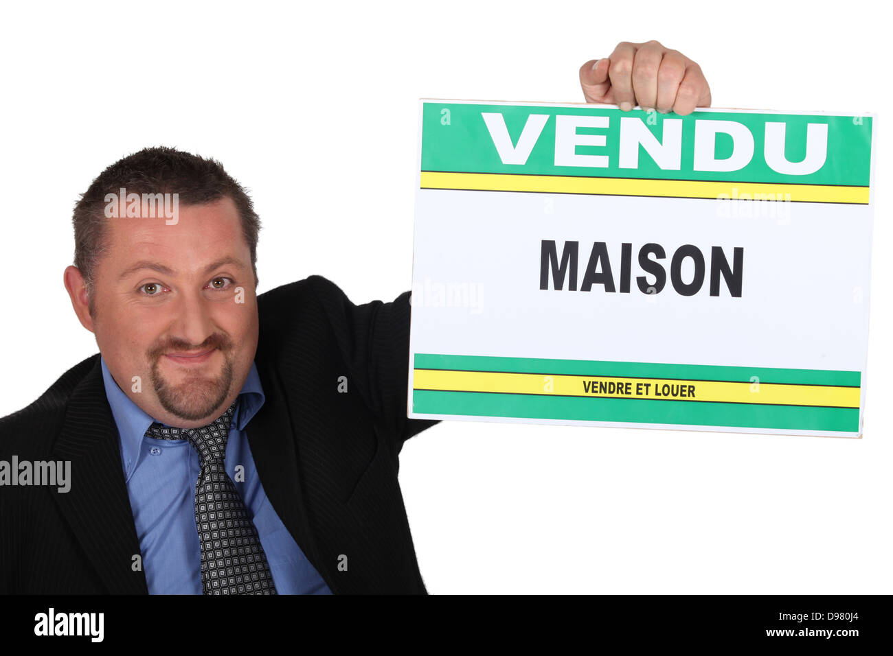 Estate agent holding a 'Vendu' sign Stock Photo Alamy