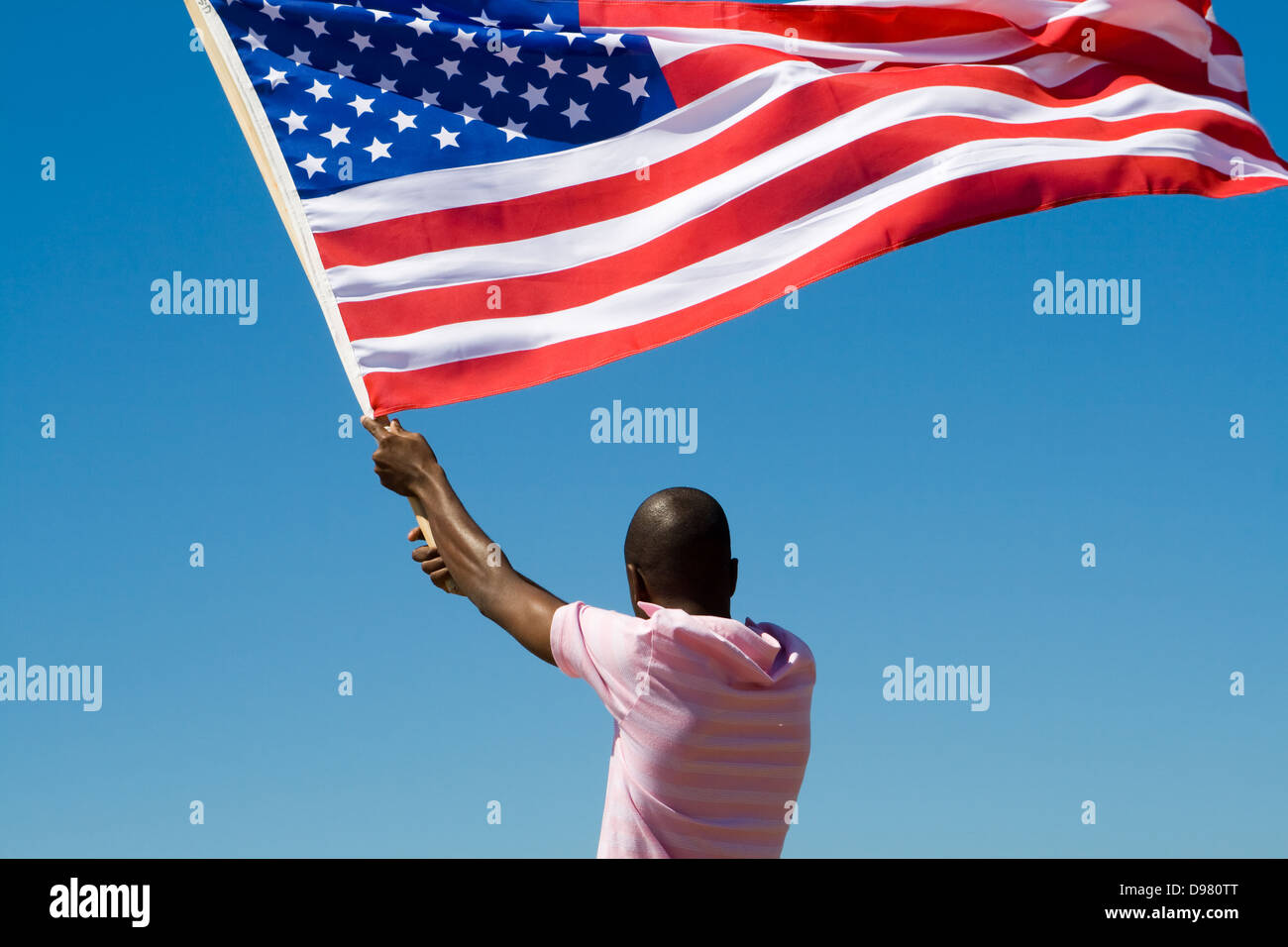 young African American man waving USA flag Stock Photo - Alamy