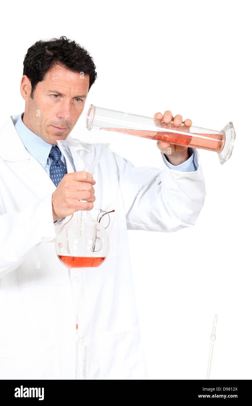 Chemist using a graduated cylinder Stock Photo