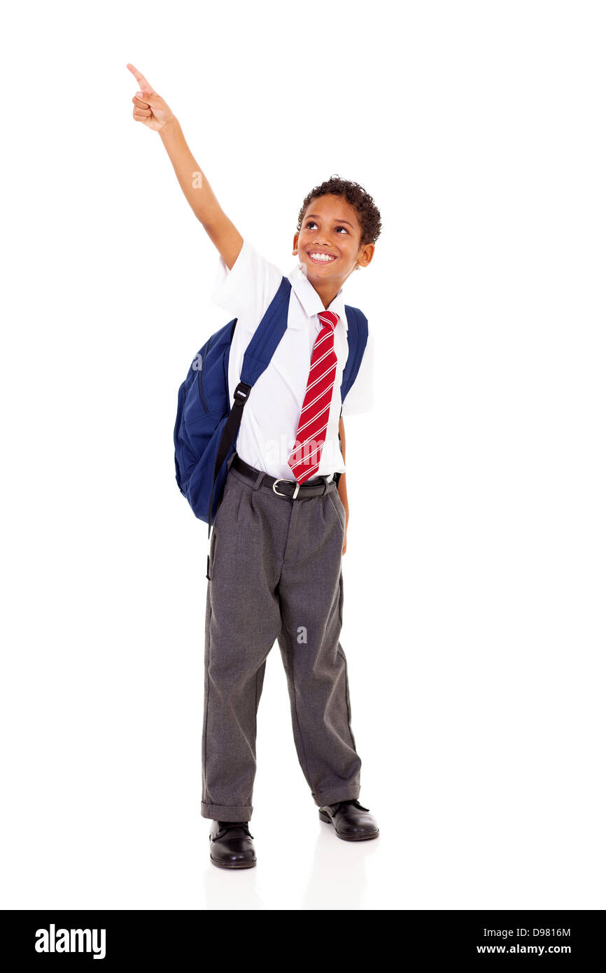 primary schoolboy pointing at empty copyspace isolated on white Stock Photo
