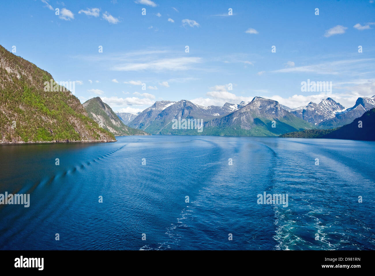 A cruise ship leaves its wake on the placid waters of the Romsdalfjord, Norway Stock Photo