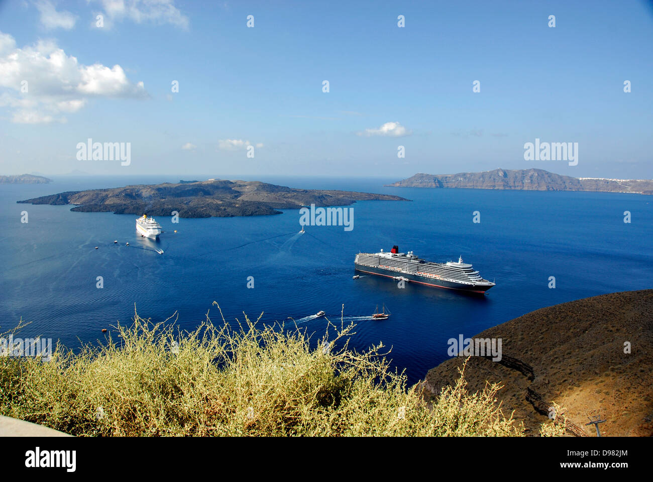 View of sea filled volcanic caldera lagoon from the cliff-top town of Fira on the Island of Santorini in the Aegean Sea, Greece Stock Photo