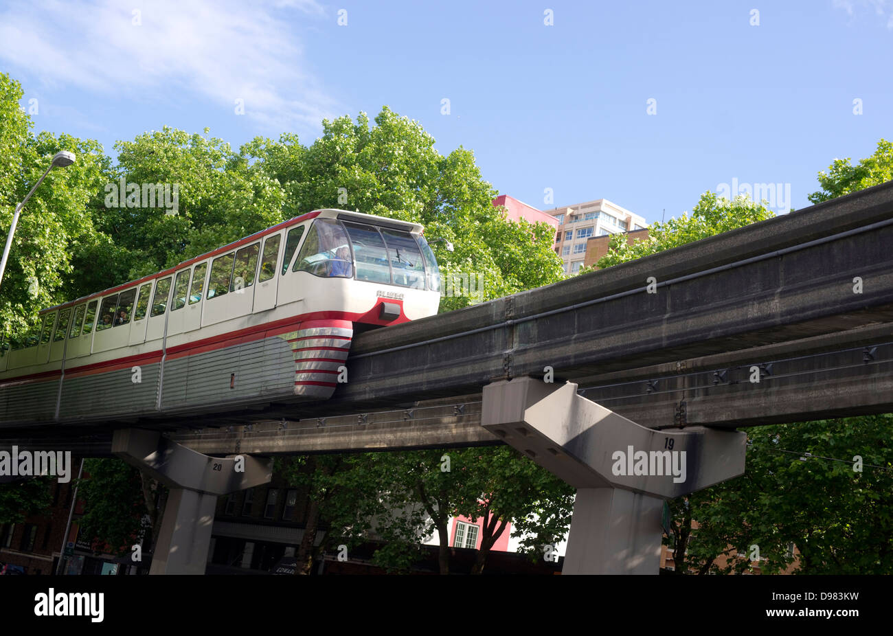 A train passes overhead via elevated rail in downtown Seattle Stock Photo