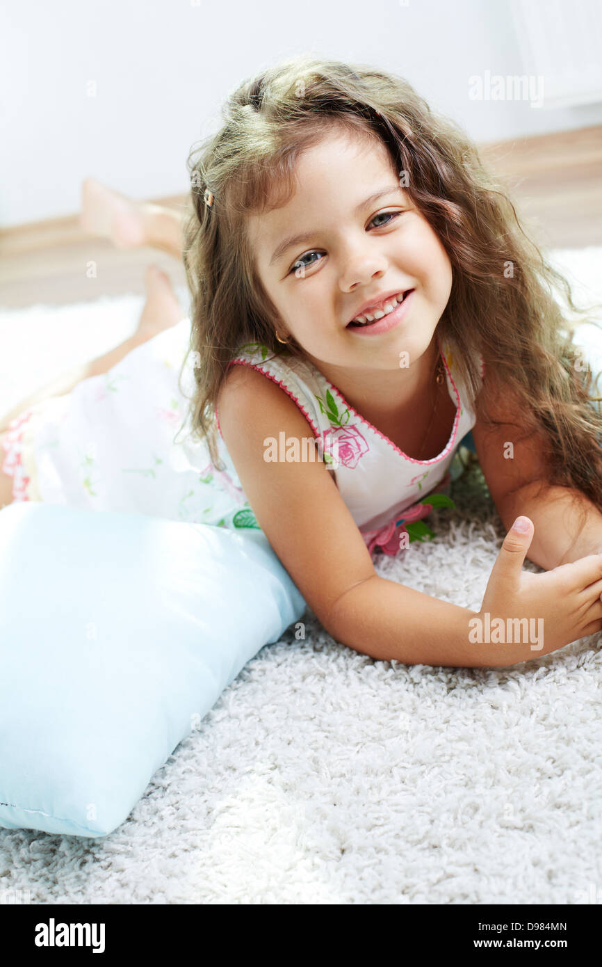 Portrait of lovely girl lying on the floor at home Stock Photo - Alamy