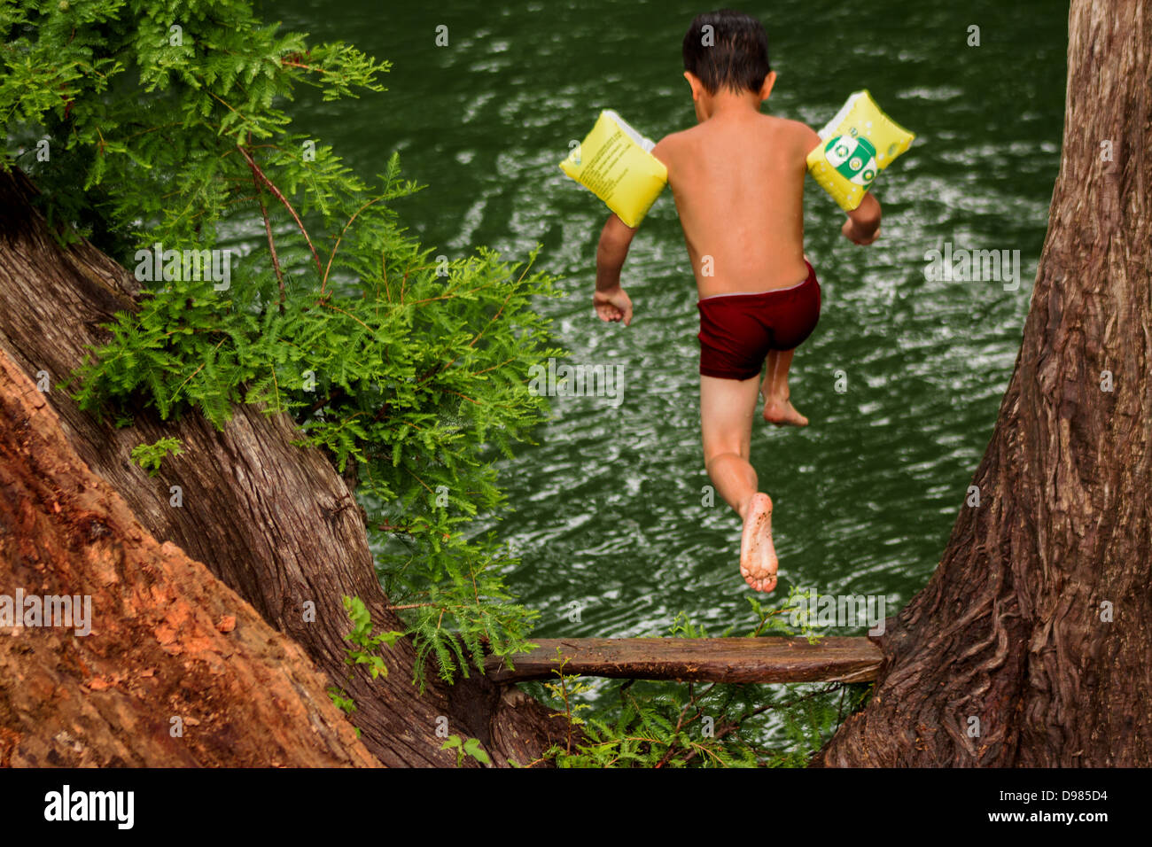 Little boy jumping into a river in Bandera, TX Stock Photo Alamy