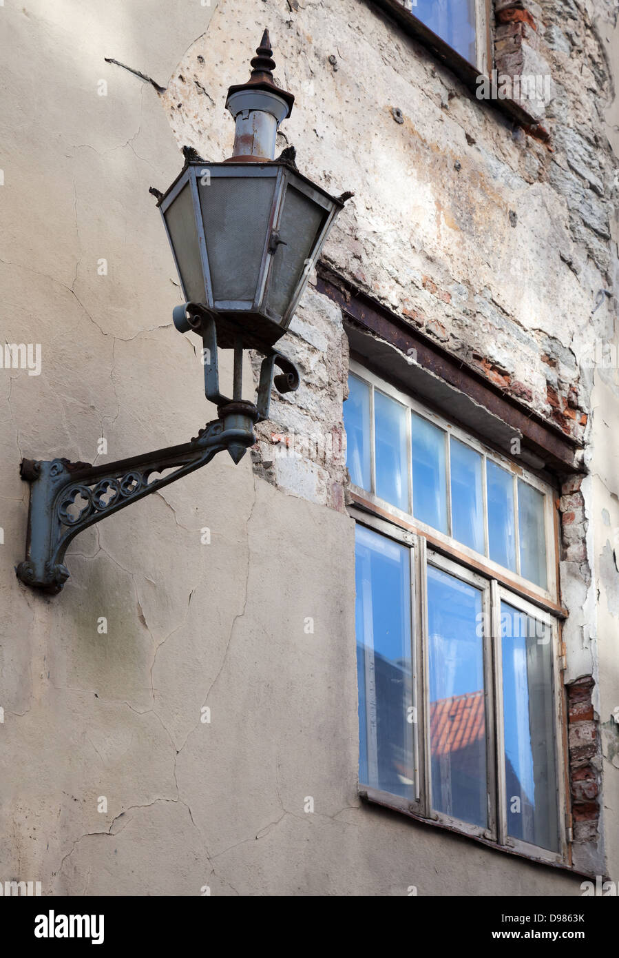 Old street lamp lantern on a weathered wall in Tallinn, Estonia Stock Photo