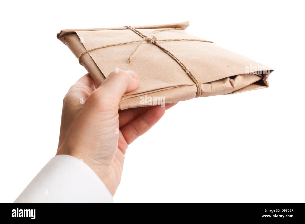 Male hand delivers full envelope tied with a rope isolated on white background Stock Photo