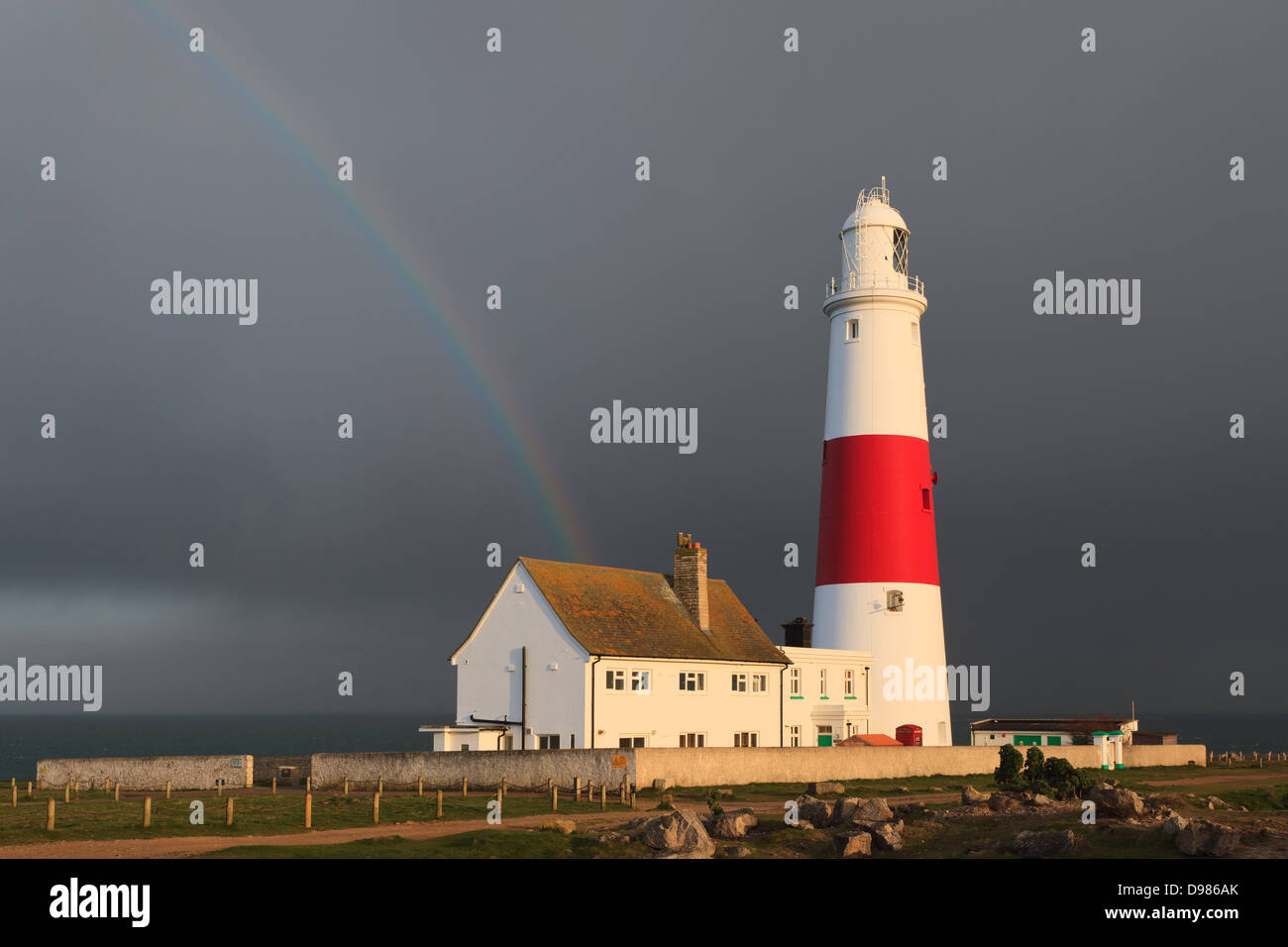 A rainbow over Portland Bill lighthouse in Dorset England Stock Photo