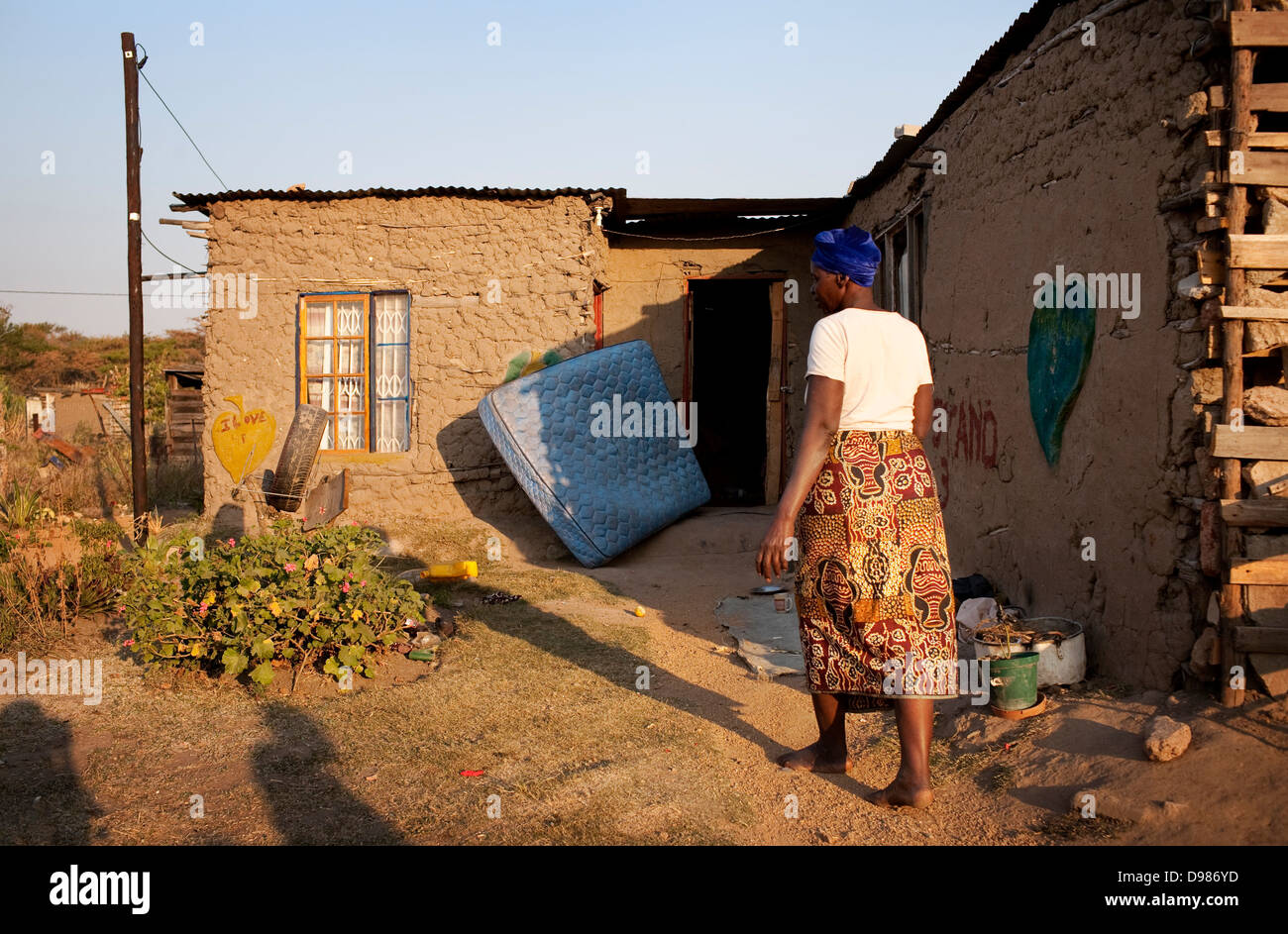 Esther Khoza 57-year-old mother three lives in mud shack without electricity running water or toilet in shadow Mbombela Stadium Stock Photo