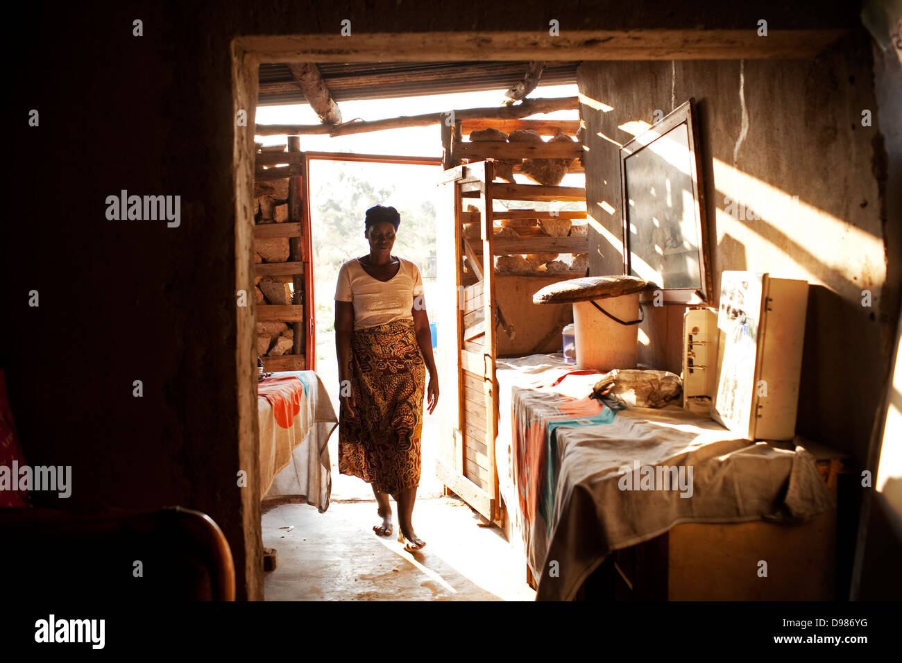 Esther Khoza 57-year-old mother three lives in mud shack without electricity running water or toilet in shadow Mbombela Stadium Stock Photo