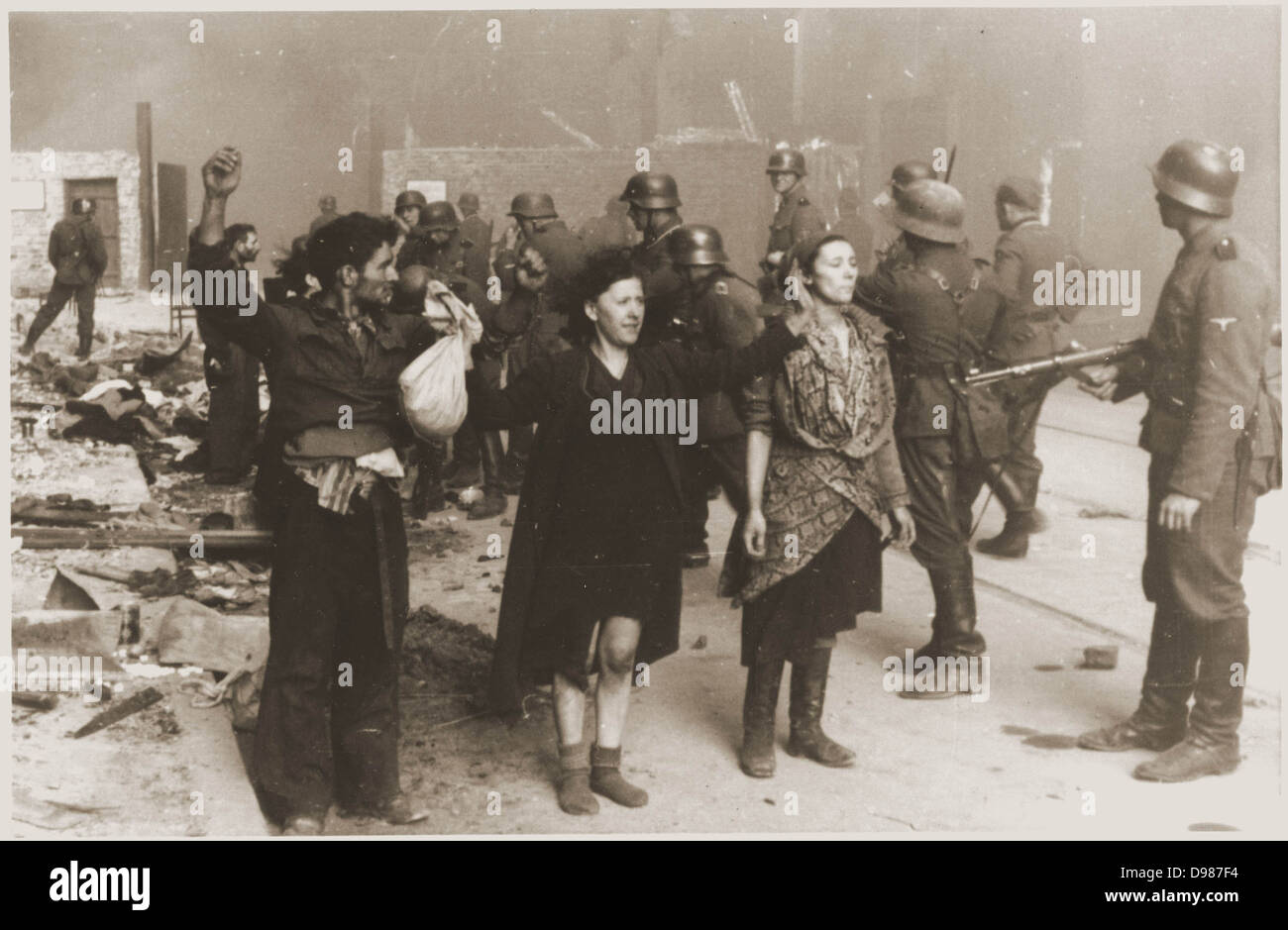 German Nazi SS troops guarding members of the Jewish resistance captured during the suppression of the Warsaw ghetto uprising in 1943. About 13,000 Jews died during the uprising. Most of the remaining 50,000 residents of the ghetto were captured and sent to concentration and extermination camps. Stock Photo