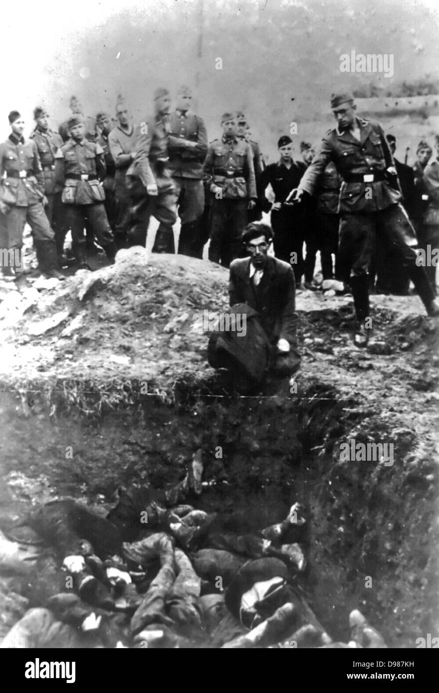 The Final Solution to the Jewish Question: An Einsatzgruppe D soldier about to shoot a Jew kneeling at a partially filled mass grave in Vinnitsa, Ukrainian SSR, Soviet Union, in 1942. The Einsatzgruppen were SS paramilitary task forces whose main purpose was the extermination of Jews. Stock Photo