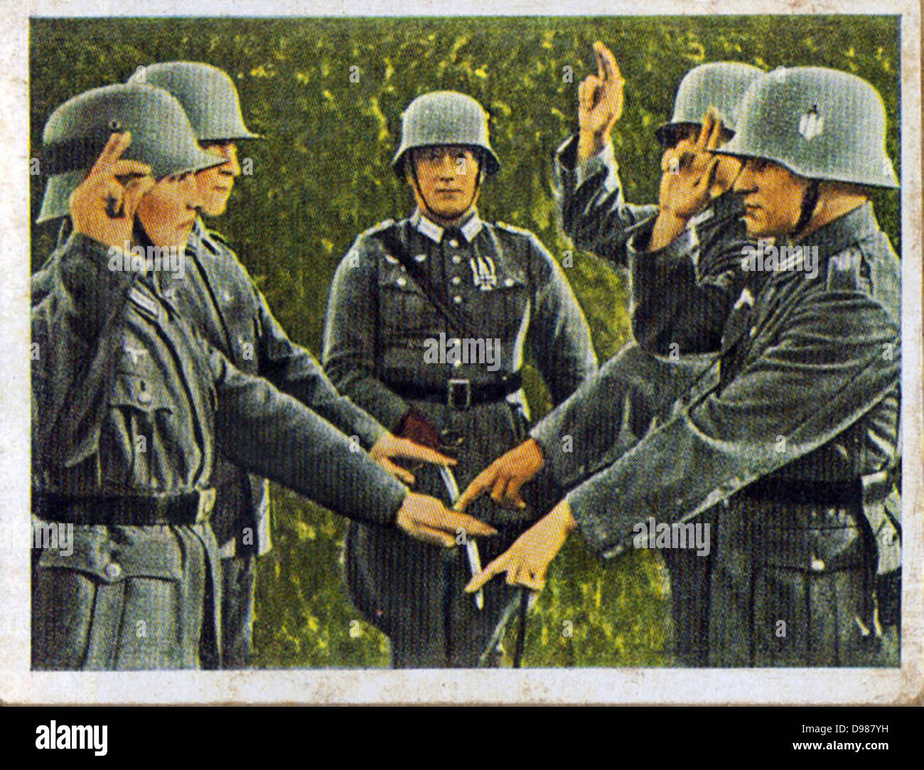 German re-armament and militarisation: German army recruits taking their oath of loyalty on the flag. From series of 270 cigarette cards 'Die Deutsche Wehrmacht', Dresden, 1936. Stock Photo