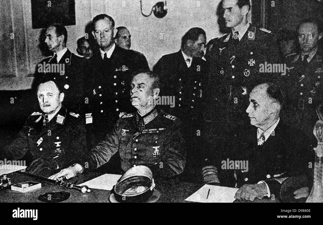 German services chiefs sign the surrender May 8, 1945.  Above, L to R, P.F. Stumpf, appointed C.-in-C, the Luftwaffe Reich, Field-Marshal Wilhelm Keitel, Chief of the Supreme Command of the Wehrmacht; and Admiral Hans Georing von Friedeburg, C.inC. Pf the German Navy.  Below  Air Marshal Sir Arthur Tedder and Marshal Zhukov sign on behalf of the Allied Expeditionary Force and the Russian High Command respectively.  On Sir Arthur's right is Mr V Vyshinsky, Soviet Vice-Commissar for Foreign affairs. Stock Photo