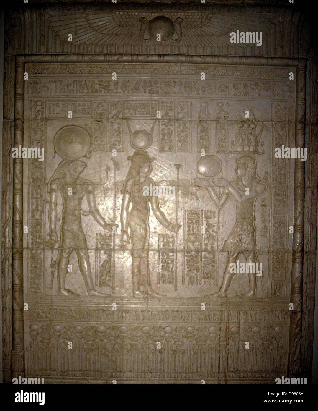 Egyptian Tomb relief showing Isis and Horus receiving offerings from a Pharaoh. Stock Photo