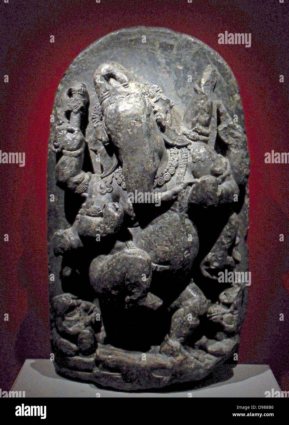 Dancing Ganesha Stone sculpture western India, AD 650-750. Dancing merrily the elephant god Ganesha (Hindu), is flanked by musicians and holds food. Stock Photo