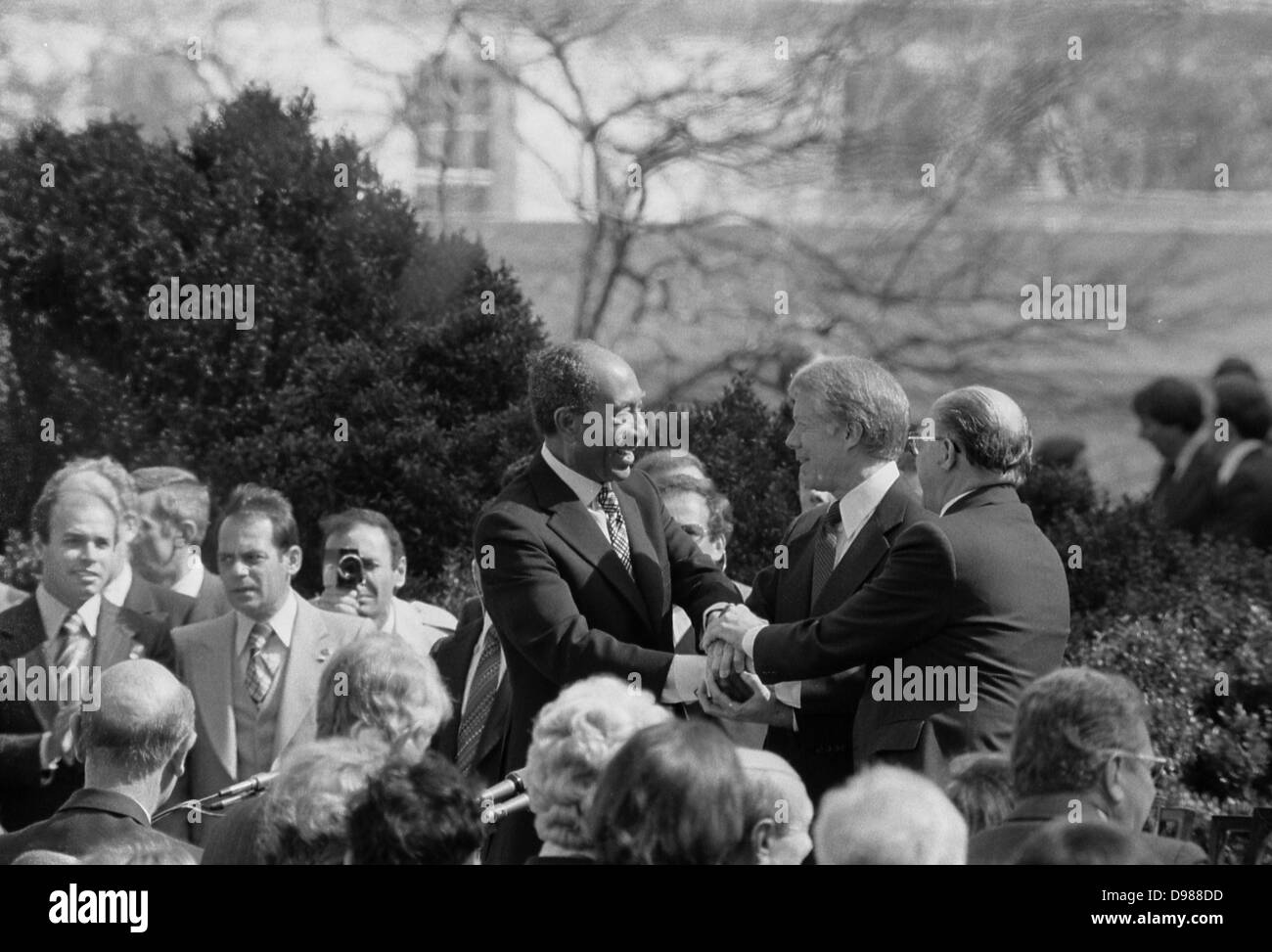 Egypt-Israel peace treaty: Jimmy Carter, President of the USA, shaking hands with Anwar Sadat, President of Egypt, and Menachem Begin, Prime Minister of Israel, at the signing of the Egyptian-Israeli Peace Treaty in the grounds of the White House, Washington, 26 March 1979. Photographer, Warren K Leffler. Stock Photo