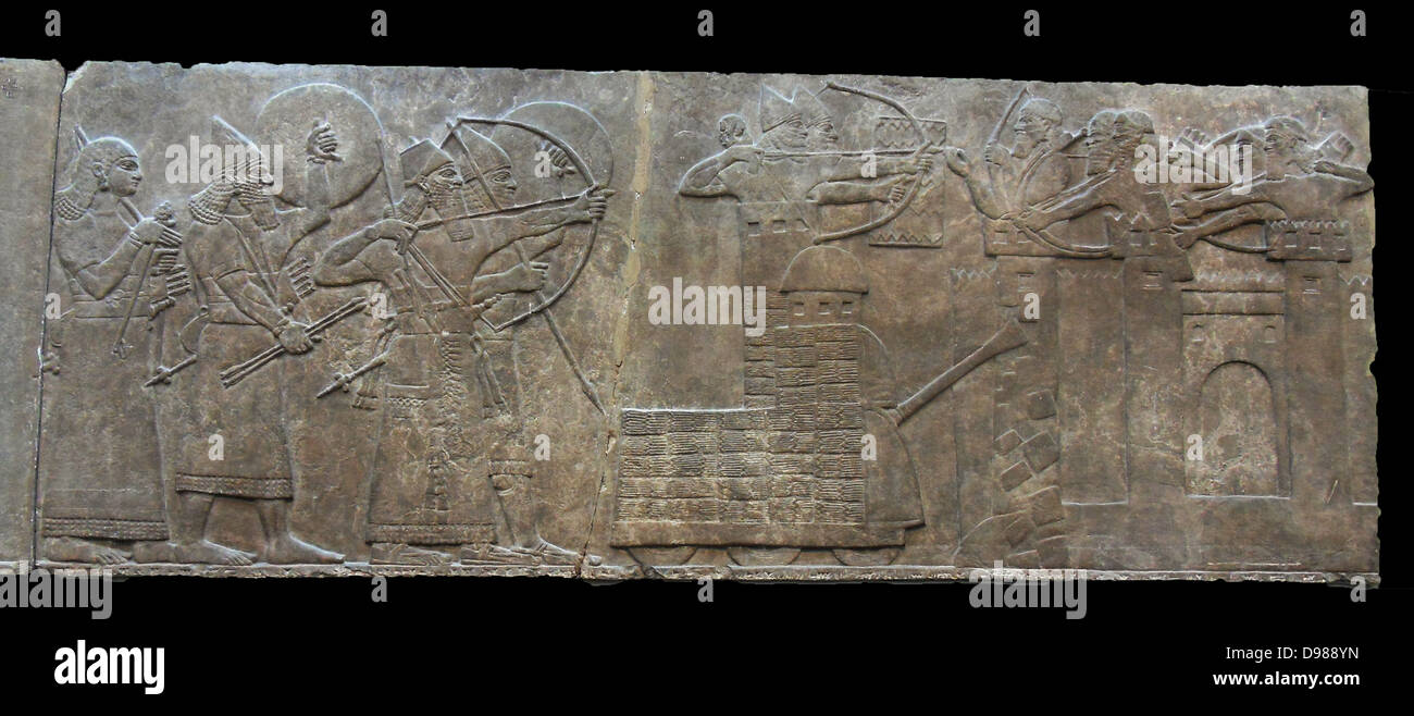 King Ashurnasirpal leads an attack on an enemy town. Siege engine and archers are shown. Assyrian relief 865-860 BC from Nimrud Stock Photo