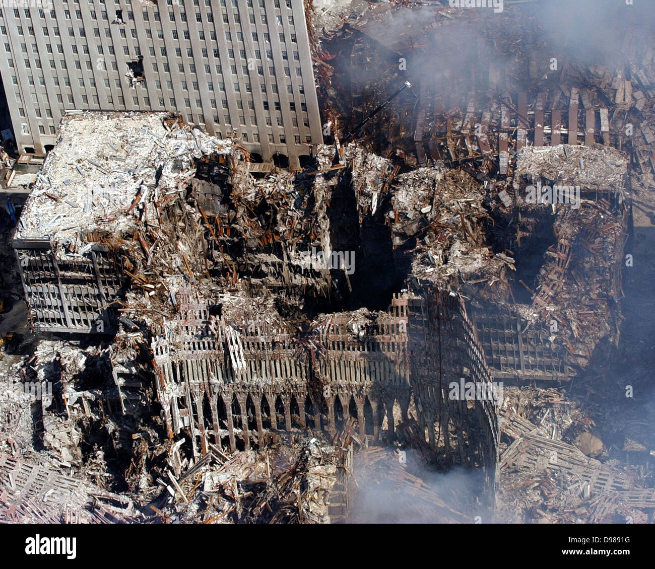 aerial view shows only a small portion of the crime scene where the World Trade Center collapsed following the Sept. 11 terrorist attack. Surrounding buildings were heavily damaged by the debris and massive force of the falling twin towers. Clean-up efforts are expected to continue for months. U.S. Navy photo Stock Photo