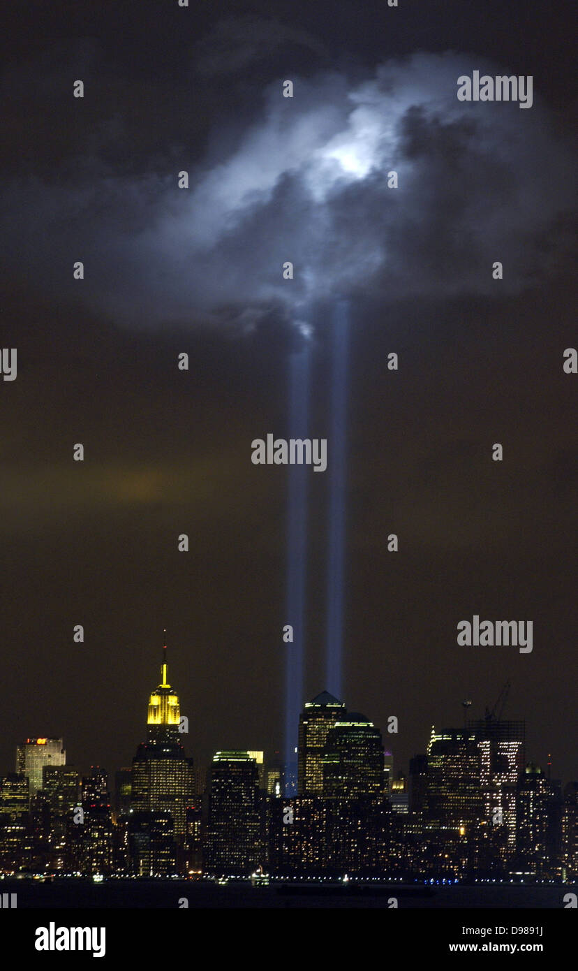 New York City, N.Y. (Sept. 9, 2004) - As the anniversary of the September 11, 2001 terrorist attack approaches, a test of the Tribute in Light Memorial illuminates a passing cloud above lower Manhattan. The twin towers of light, made-up of 44 searchlights near “Ground Zero,” are meant to represent the fallen twin towers of the World Trade Center. Depending on weather conditions, the columns of light can be seen for at least 20 miles around the trade center complex. U.S. Coast Guard photo Stock Photo