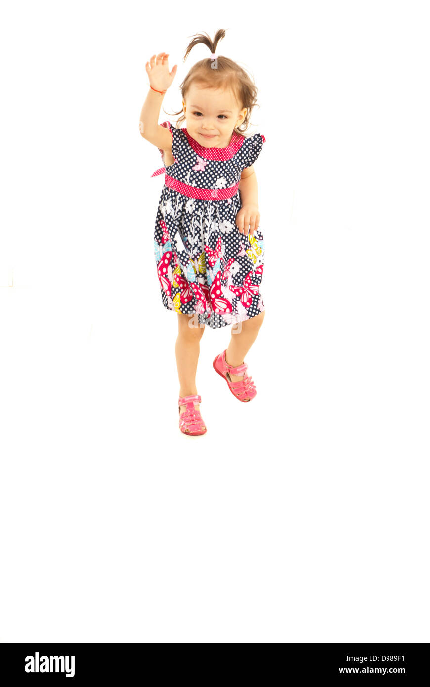 Little girl trying to jump isolated on white background Stock Photo - Alamy