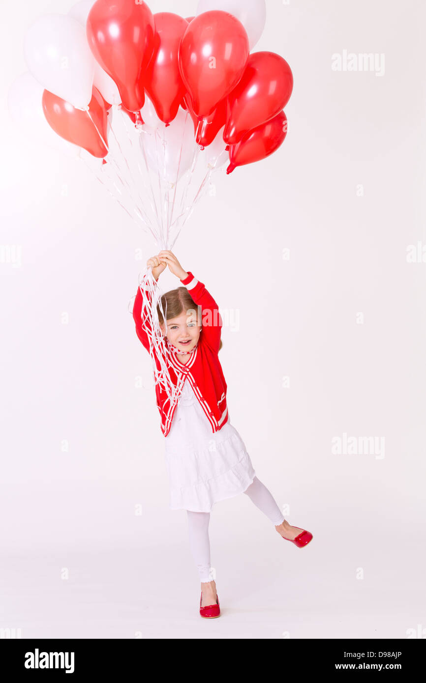 Girl flying bunch balloons hi-res stock photography and images - Alamy