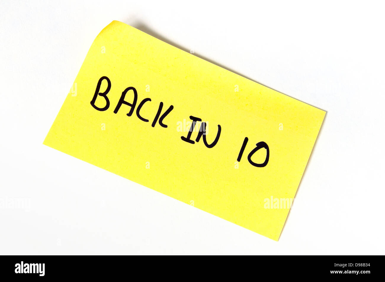 Back in 10 written on a yellow post-it note Stock Photo