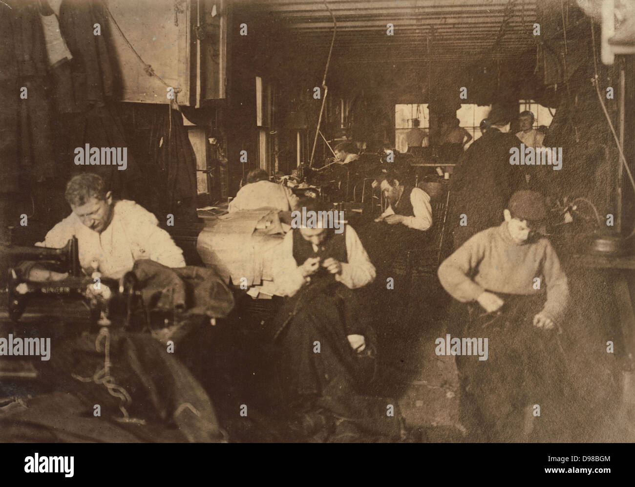 Immigrant workers: Men and a boy in a New York sweatshop, c1910. Photograph. Stock Photo