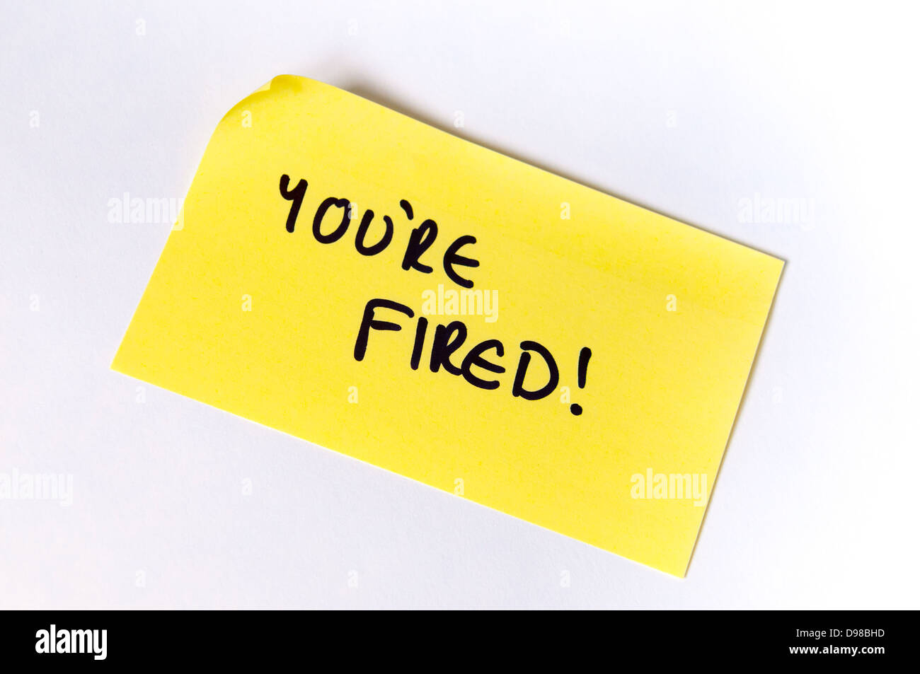 You're Fired! Written on a yellow post it note Stock Photo